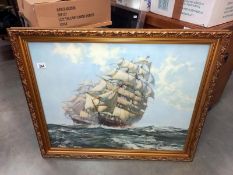 A large gilt framed print of 2 Galleon sailing ships.