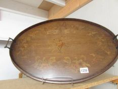 An oval mahogany inlaid tray.