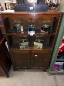 A 1920's oak bookcase with 2 cupboard doors (80cm x 21cm x 125cm high)