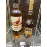 A bottle of The Famous Grouse whiskey and Martell Brandy.