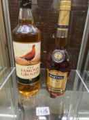 A bottle of The Famous Grouse whiskey and Martell Brandy.