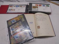 An album of approximately 50 first day covers and a stamp album.