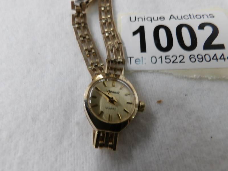 An Ingersol gold cases ladies wrist watch, needs new battery. - Image 2 of 2