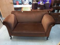 An Edwardian brown fabric covered drop end settee. 148cm wide.