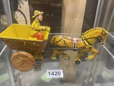 A 1950's Marx tinplate clockwork horse and cart with driver.