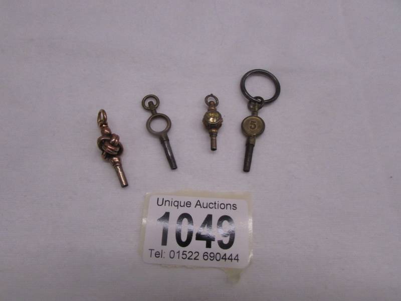 Four old pocket watch keys (one may be gold).