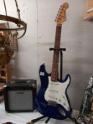 A Helmsman electric guitar with cruiser amp. Collect Only. (stand not included)