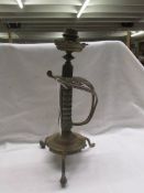 A Victorian Benham & Froud sword candlestick, one leg a/f.