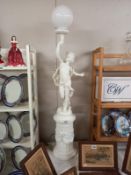 A Roman style cherub on plank, floor standing lamp. Height 120cm. Collect Only.