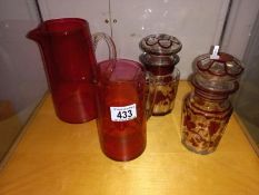 2 Cranberry glass jugs and 2 bohemian lidded glass jars.