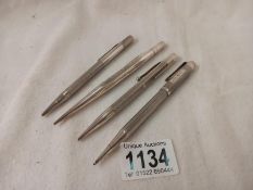 Four hall marked silver propelling pencils including Yard-O-Lead.