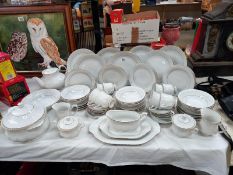 A Chodziez made in Poland, white dinner service with gilded rims.