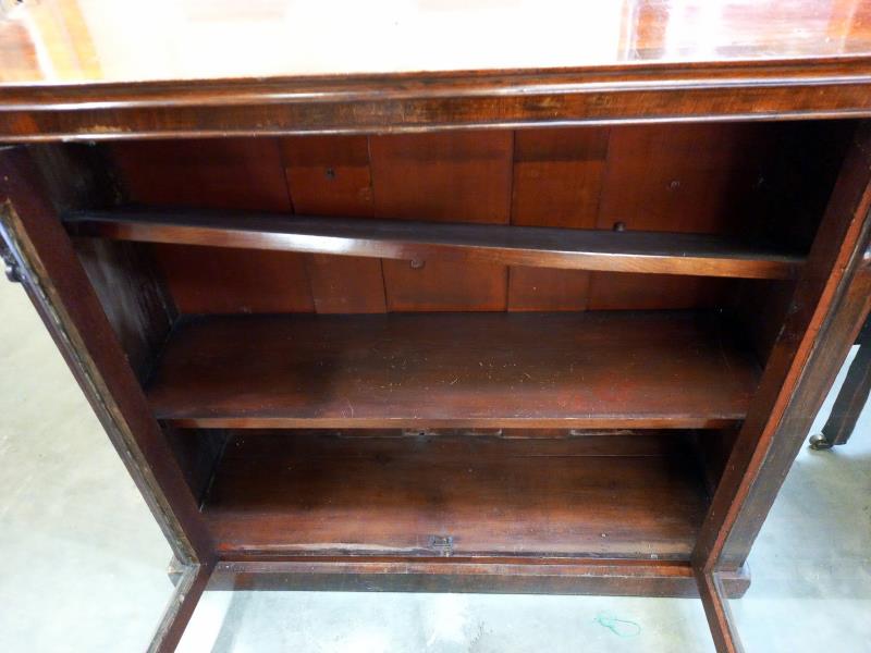 A Victorian mahogany veneered glazed bookcase. 107 cm x 34cm x height 97cm. - Image 2 of 2