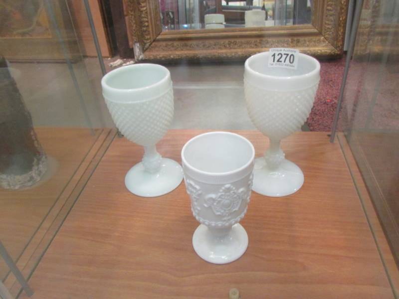 A pair of opaline glass goblets and one other.