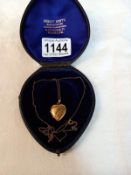 A gold heart shaped locket in case (5gms)