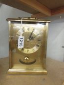 A brass quartz clock by H Samuel.