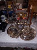 A good selection of silver plate including tureen, bottle stand and candle lamp with amber glass