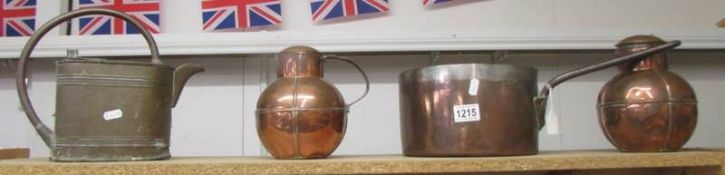 A Victorian copper saucepan, a brass watercan and two copper lidded pots (one missing handle).