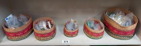 A good selection of vintage buttons in graduated wicker lidded baskets.