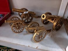 Two pairs of solid brass cannons.