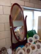 A dark wood stained cheval mirror.