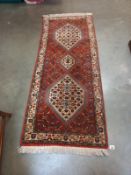 A middle eastern floral pattern rug. 186cm x 73cm.