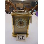 A brass carriage clock with key.