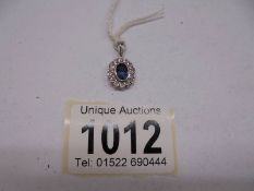 A white gold diamond and tanzanite pendant, 1.8 grams. (no hall mark).