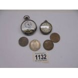 A lady's silver fob watch, a pocket watch and four coins.