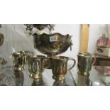 A silver plate punch bowl and six half pint tankards..