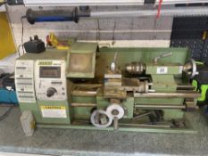 A Warco lathe with large collection of chucks, gears and cutting tools.