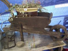 A working ornamental wheel barrow and a potted vine. COLLECT ONLY.