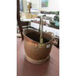 A copper coal scuttle.