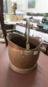 A copper coal scuttle.