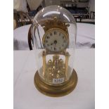 A 1912 400 day Torsion clock by Jaurensuren Fabric under glass dome.