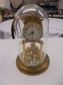 A 1912 400 day Torsion clock by Jaurensuren Fabric under glass dome.