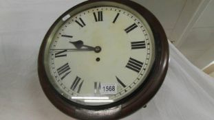 A circular chain driven wall clock.