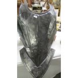A metal armour breast plate.