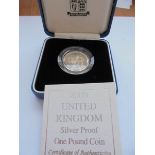 A cased 2000 silver proof £1 Wales coin with certificate.
