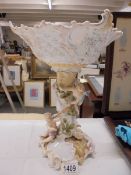 A continental porcelain cherub decorated table centrepiece.