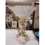 A continental porcelain cherub decorated table centrepiece.