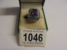 A circa 1960/70's silver amethyst stone set silver ring with heavy textured mount, size M.