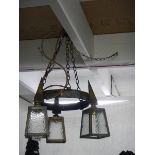 An arts and crafts brass triple lantern ceiling light. COLLECT ONLY.
