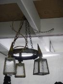 An arts and crafts brass triple lantern ceiling light. COLLECT ONLY.