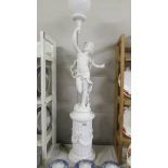 A floor standing cherub lamp on plinth, COLLECT ONLY.