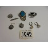 An Edwardian silver 'Baby' brooch together with two silver brooches, silver ear pendants set with