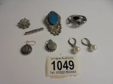 An Edwardian silver 'Baby' brooch together with two silver brooches, silver ear pendants set with