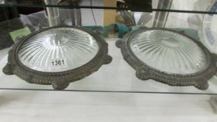 A pair of ornate metal and glass 'portholes'.