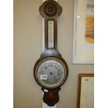 A 1930's oak aneroid barometer.