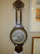 A 1930's oak aneroid barometer.